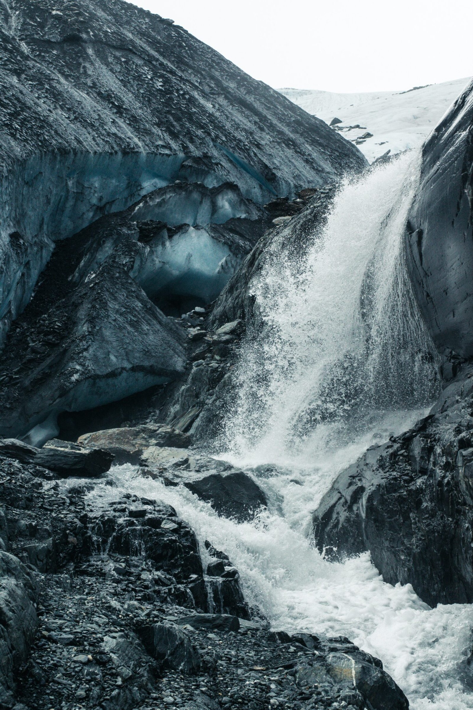body of water between rock formation at daytime